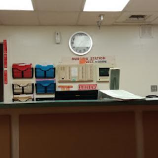 A view of a reception area featuring various mailboxes and a wall clock.