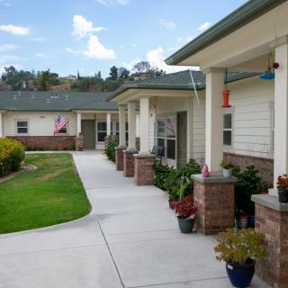 A serene residential housing complex with a well-maintained pathway and garden.