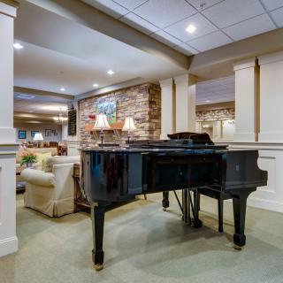 A luxurious living room featuring a grand piano and elegant interior design.