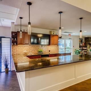 A modern kitchen with pendant lighting and a spacious countertop.