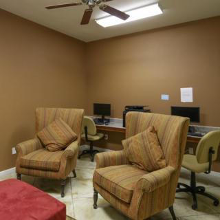 A cozy office space with comfortable seating and computer workstations.