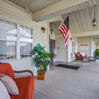 A cozy front porch with comfortable seating and an American flag.