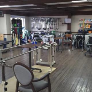 A rehabilitation room equipped with various physical therapy tools and equipment.