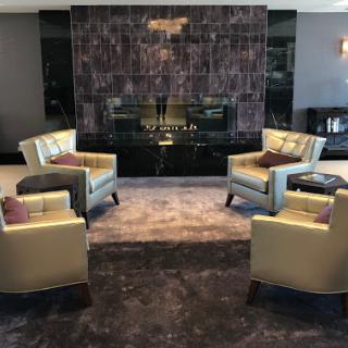 A stylish living room featuring modern chairs, a sleek fireplace, and elegant decor.