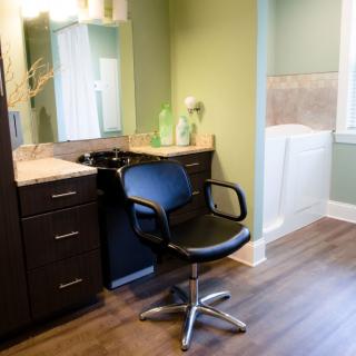 A modern salon setup with a styling chair and vanity mirror.