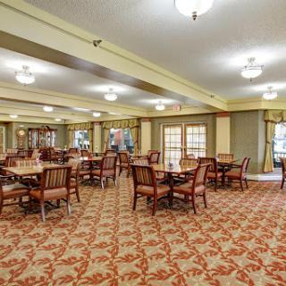 A spacious dining area featuring elegant furniture and a warm atmosphere.