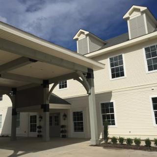 Modern building with a covered entrance and bright exterior on a sunny day.