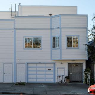 A residential house with a garage on a quiet street.