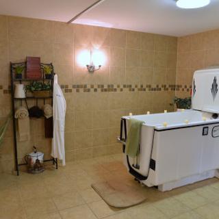 A serene bathroom space featuring a large bathtub and neatly arranged towels, perfect for relaxation.
