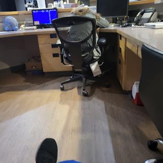 A view of an office workspace with a computer desk and chair.