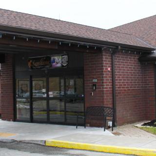A brick commercial building with a glass entrance.