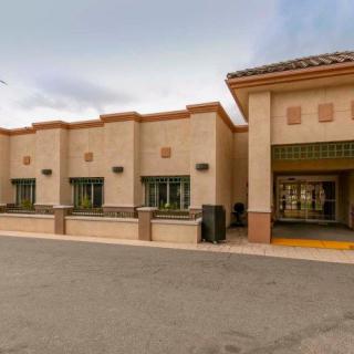 A view of a commercial building with multiple windows and a flat roof design.