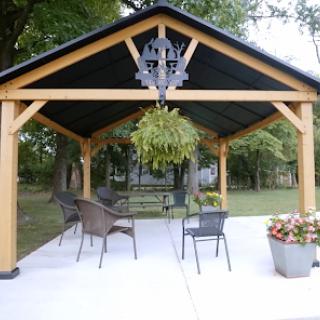 A cozy outdoor pavilion with comfortable seating, perfect for relaxation in the garden.