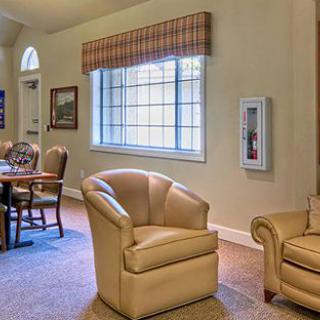 A cozy living room with comfortable seating and a large window.