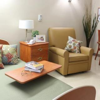 A cozy living room with an armchair, coffee table, and decorative elements.