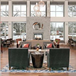 A modern lounge area with stylish furniture and large windows overlooking a snowy landscape.