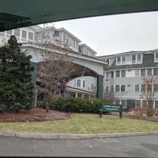 A view of a residential building with landscaped surroundings.