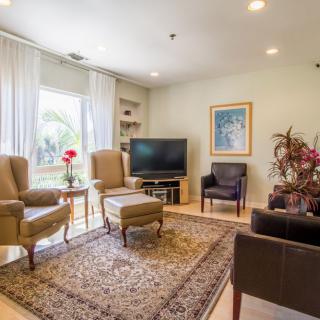A cozy living room with comfortable seating, a television, and elegant decor.