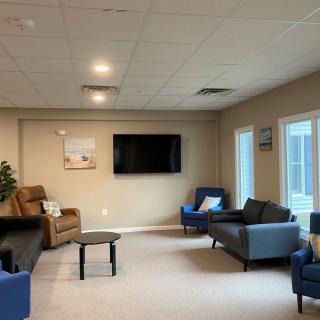 A modern living room with comfortable seating and a wall-mounted television.