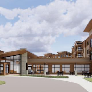 A modern multi-story building featuring a welcoming entrance and landscaped surroundings.