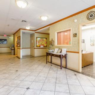 A spacious lobby area with tiled flooring and comfortable seating.