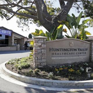 Entrance sign for Huntington Valley Healthcare Center surrounded by landscaping and trees.