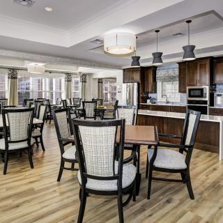 A modern dining area with wooden floors, stylish furniture, and contemporary lighting fixtures.