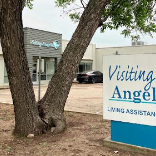 Visiting Angels - A living assistance facility located near a tree.