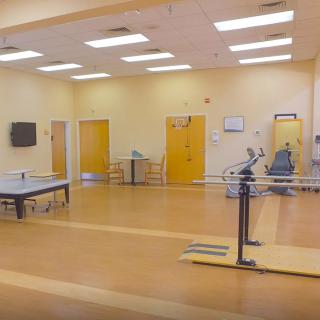 A physical therapy and rehabilitation room with various exercise equipment.