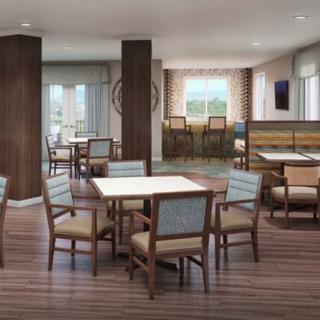 A modern dining area with tables and chairs arranged in a spacious setting.