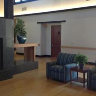 A modern lobby area with seating and decorative plants.