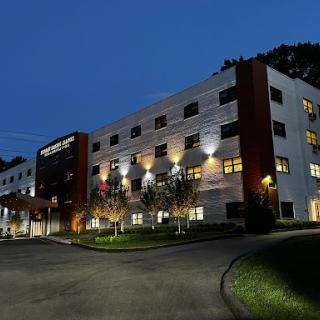 A modern healthcare facility illuminated at night.