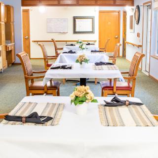 A neatly arranged dining area with tables set for a meal, showcasing elegant decor.