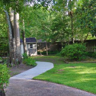 A tranquil garden pathway surrounded by lush greenery.