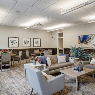 A modern lounge area with comfortable seating and decorative artwork.