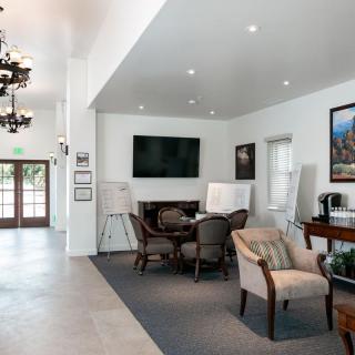 A modern lobby with comfortable seating, a large television, and stylish decor.