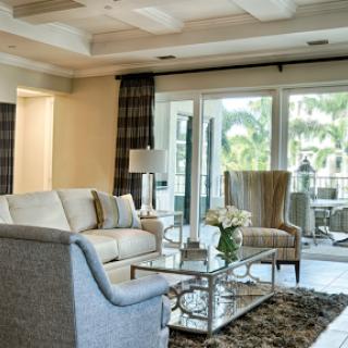 A beautifully designed living room featuring comfortable seating and elegant decor, enhanced by natural light.