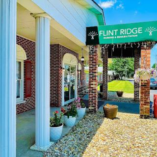 Entrance of Flint Ridge with welcoming signage and landscaped surroundings.
