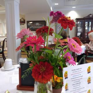 A vibrant floral centerpiece brightens up the dining area.