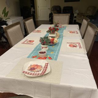 A beautifully set dining table ready for a meal, complete with decorative elements and place settings.