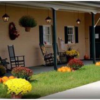 A cozy porch with rocking chairs and vibrant flowers.