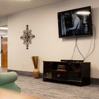 A modern living room with a wall-mounted TV and stylish decor.