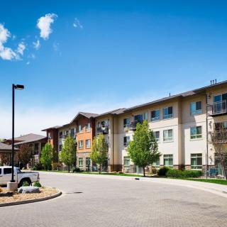 A modern apartment building in a suburban residential area on a sunny day.