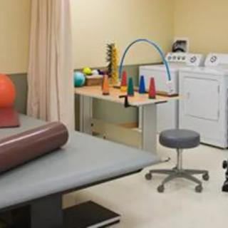 A physical therapy room equipped with various exercise devices and tools.