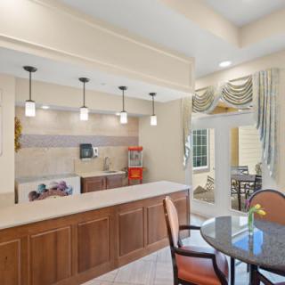 A modern kitchen interior with a countertop, pendant lights, and wood cabinetry.