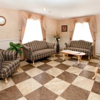 A cozy living room with striped sofas and a checkered floor.