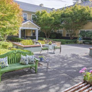 A peaceful courtyard with benches and lush greenery.
