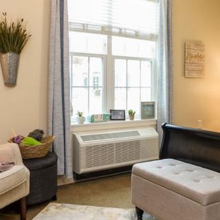 Cozy living room with a large window and comfortable seating.