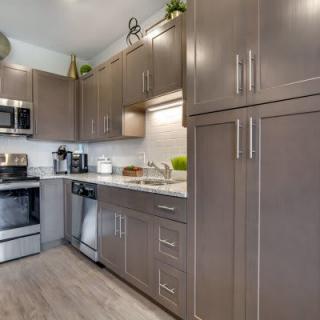 A modern kitchen with stainless steel appliances and sleek cabinetry.