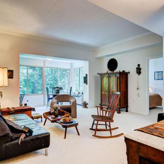 A cozy and spacious living room filled with natural light, showcasing elegant furniture and decor.